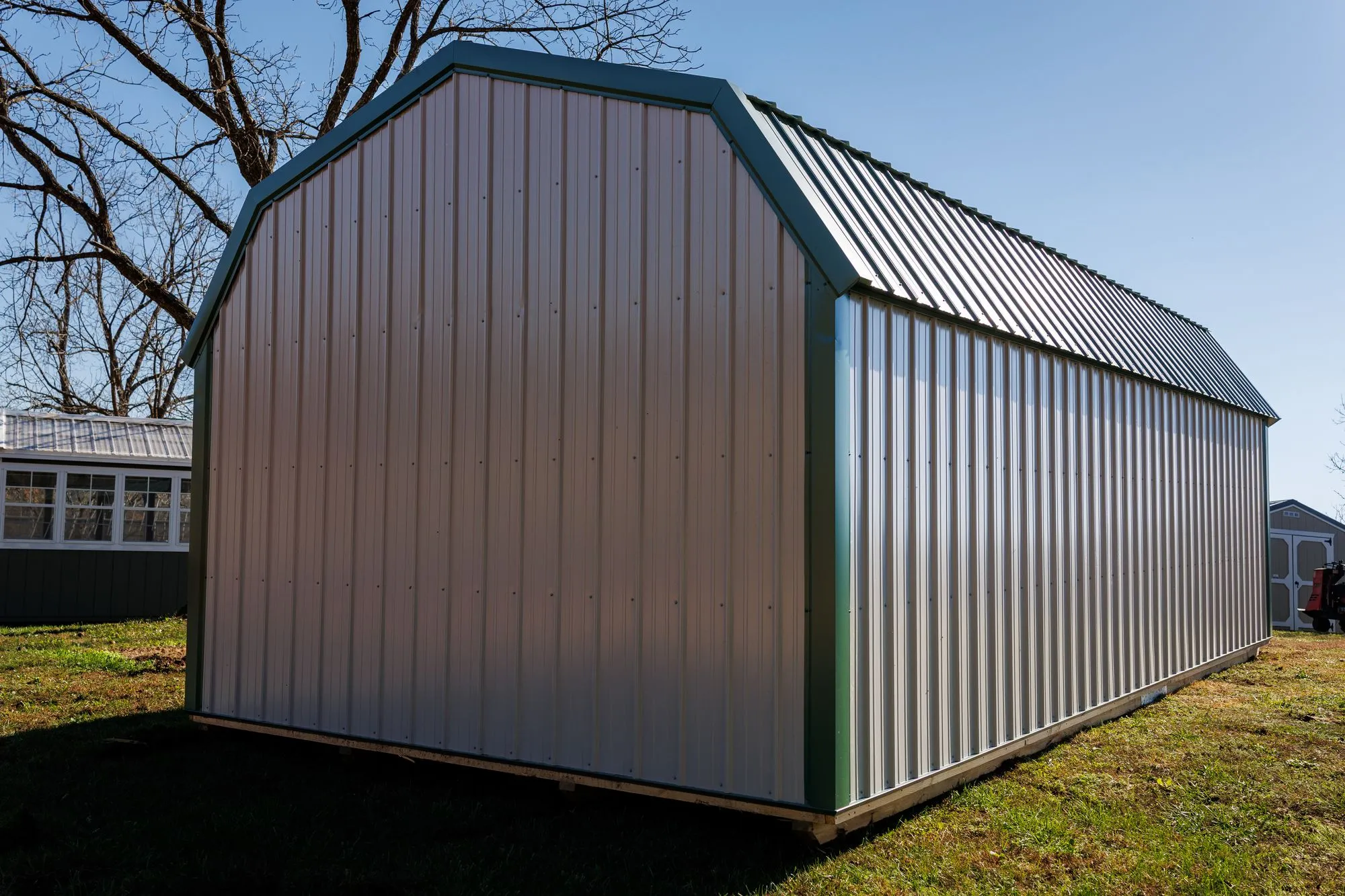 Lofted Garage with gray metal siding with green trim and roof, on the Hawthorn lot in Rocky Comfort, Missouri