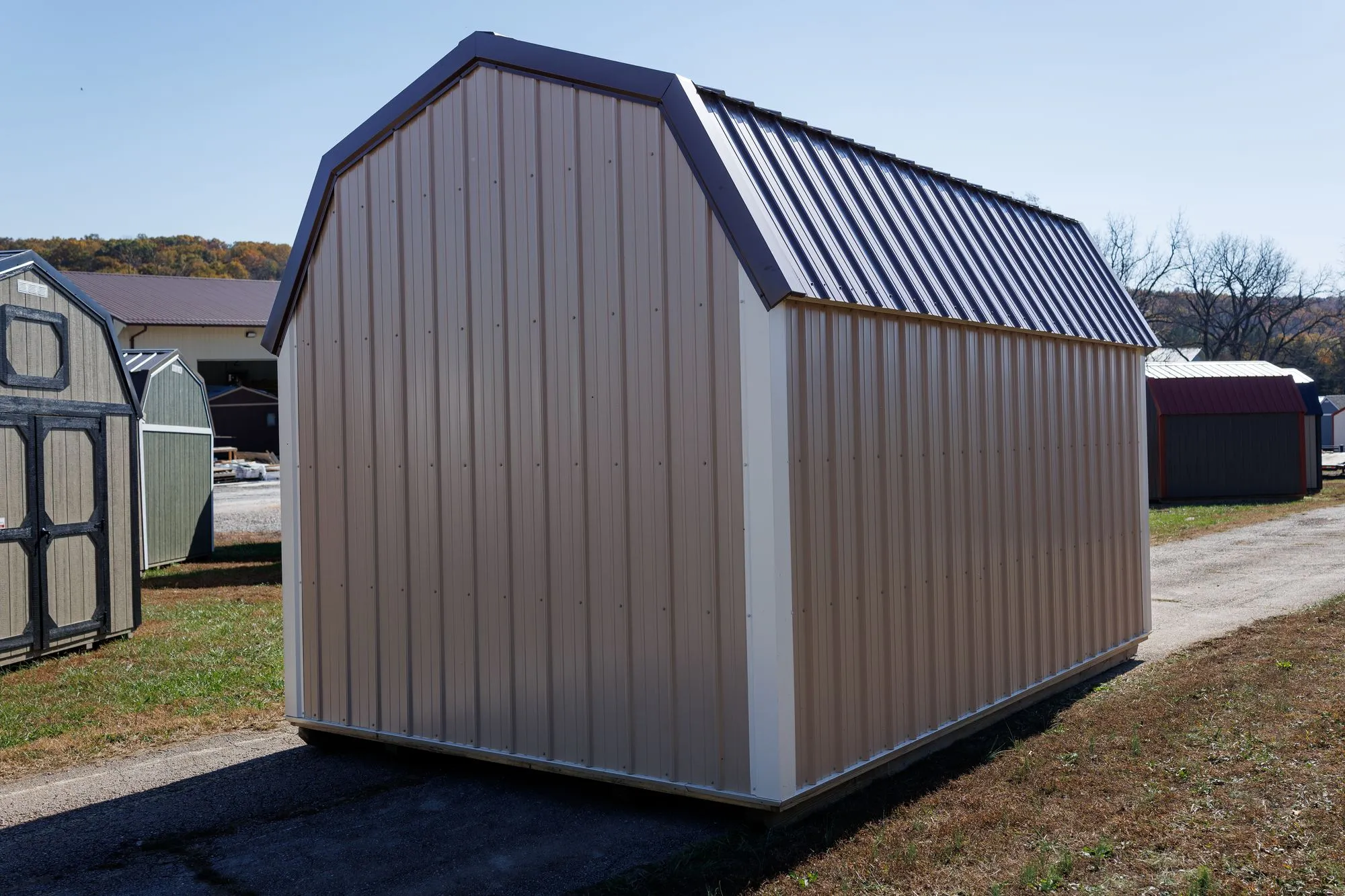 Lofted Barn with tan metal siding, white trim, brown roof, on the Hawthorn lot in Rocky Comfort, Missouri