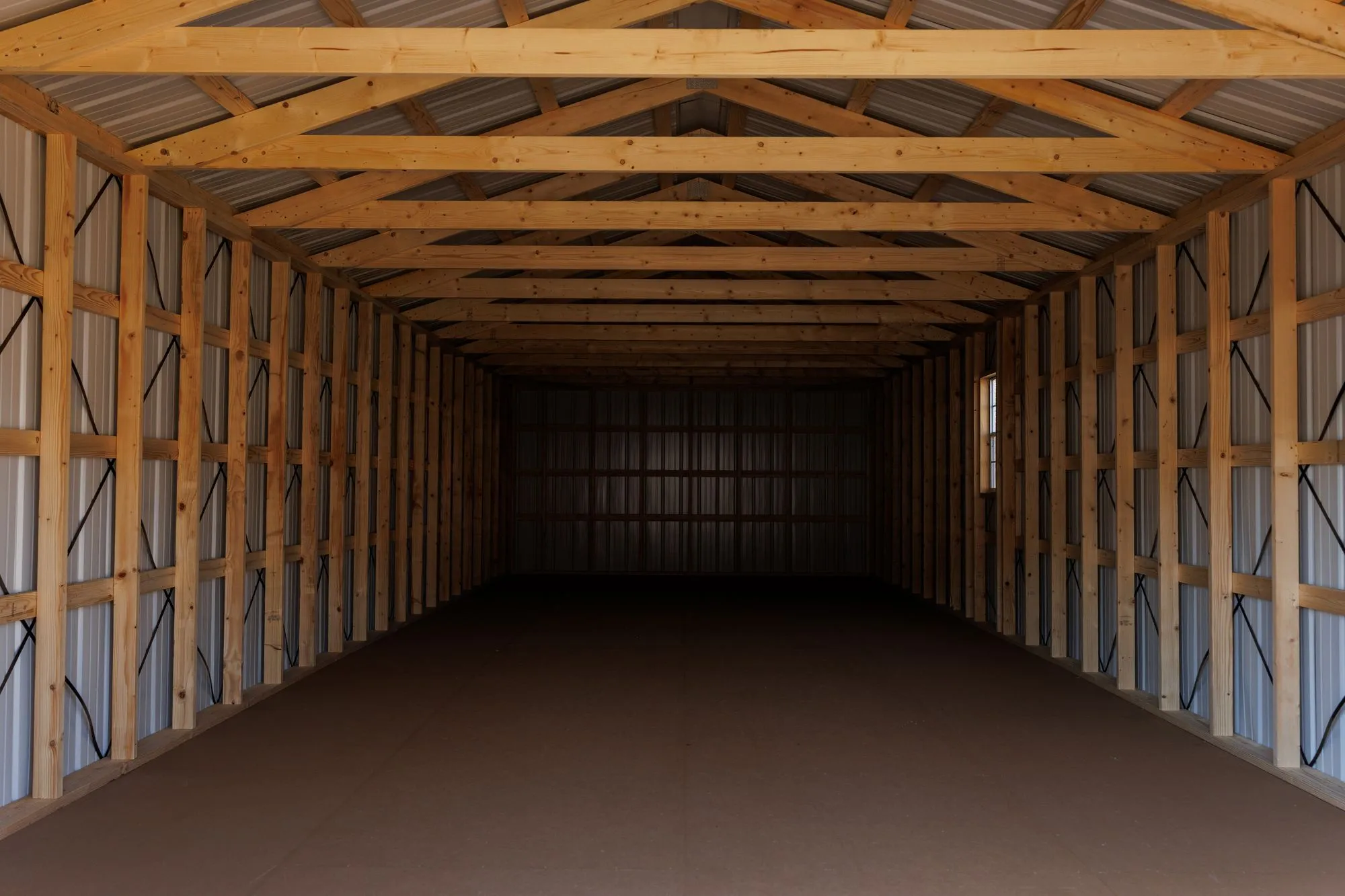 Inside a long Hawthorn Portable Garage, showing the framed walls and ceiling