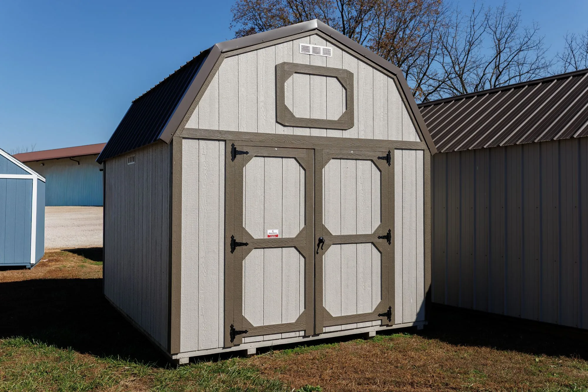 Lofted Barn with light gray siding, clay-gray trim, charcoal roof, on the Hawthorn lot in Rocky Comfort, Missouri