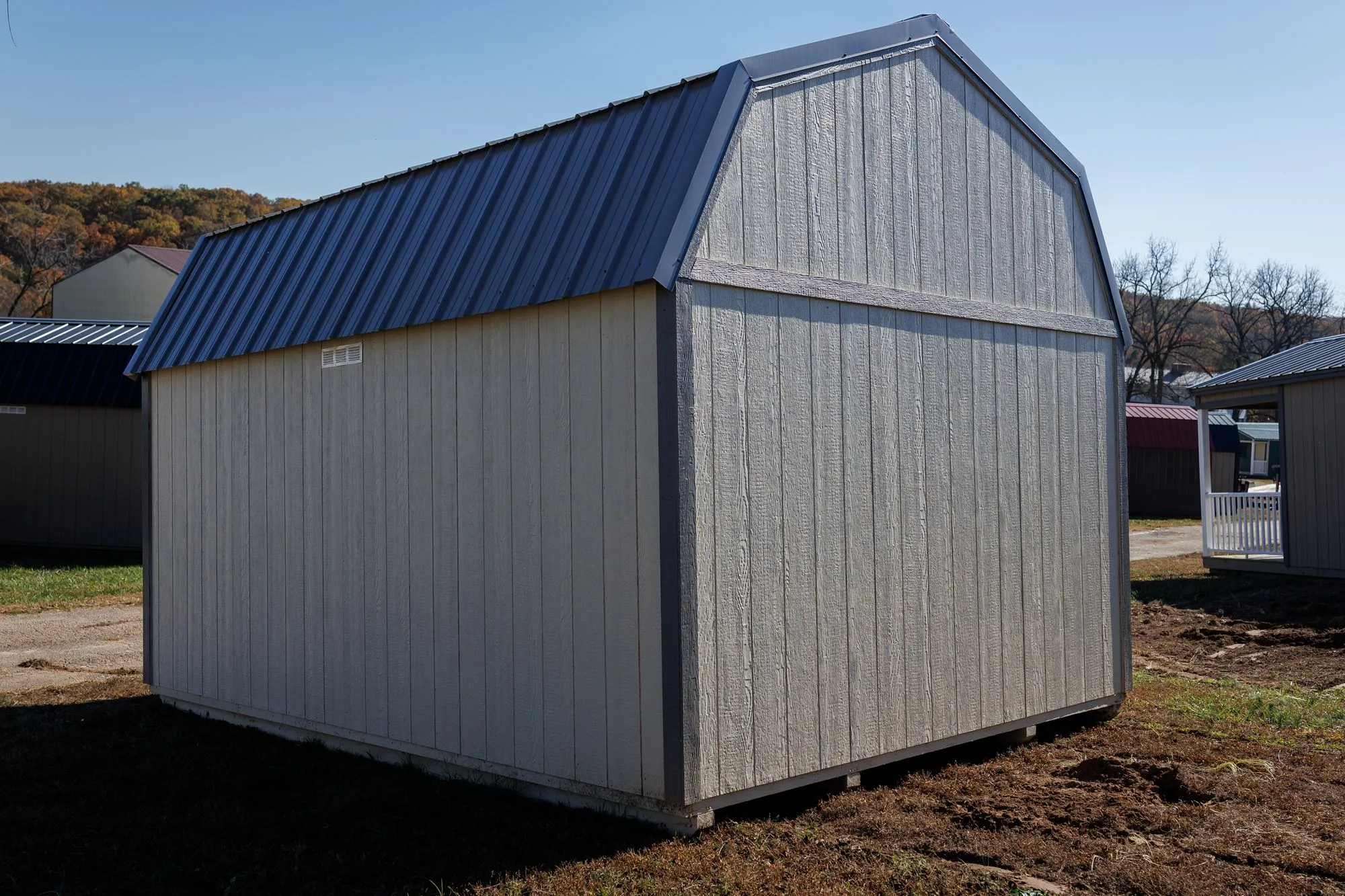 Lofted Garden Barn with cream and light-gray siding, charcoal trim, gray roof, on the Hawthorn lot in Rocky Comfort, Missouri