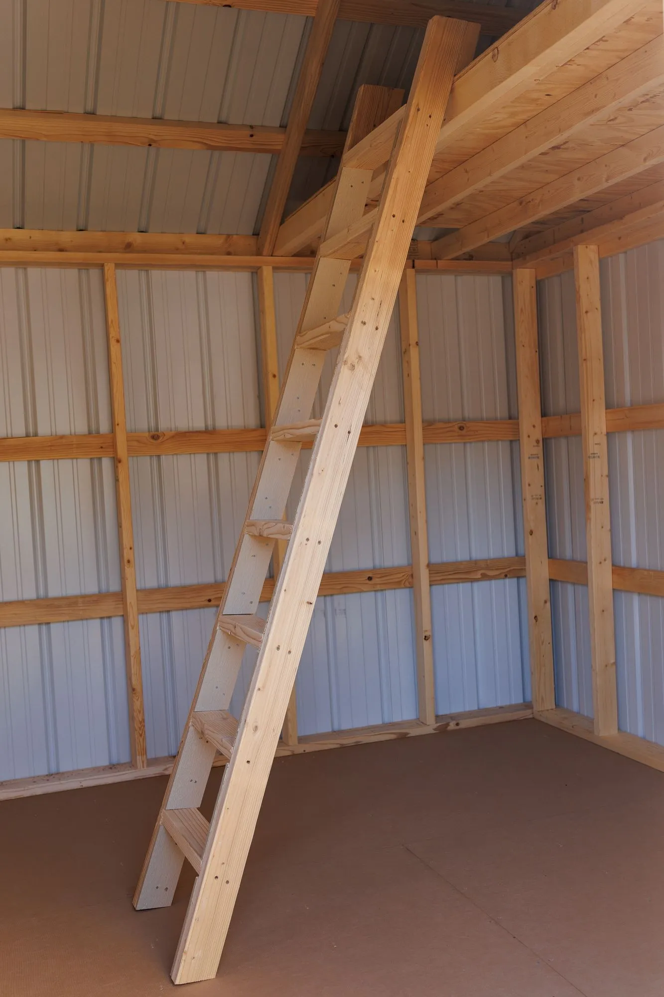 A loft deck and wooden ladder inside a Hawthorn lofted building
