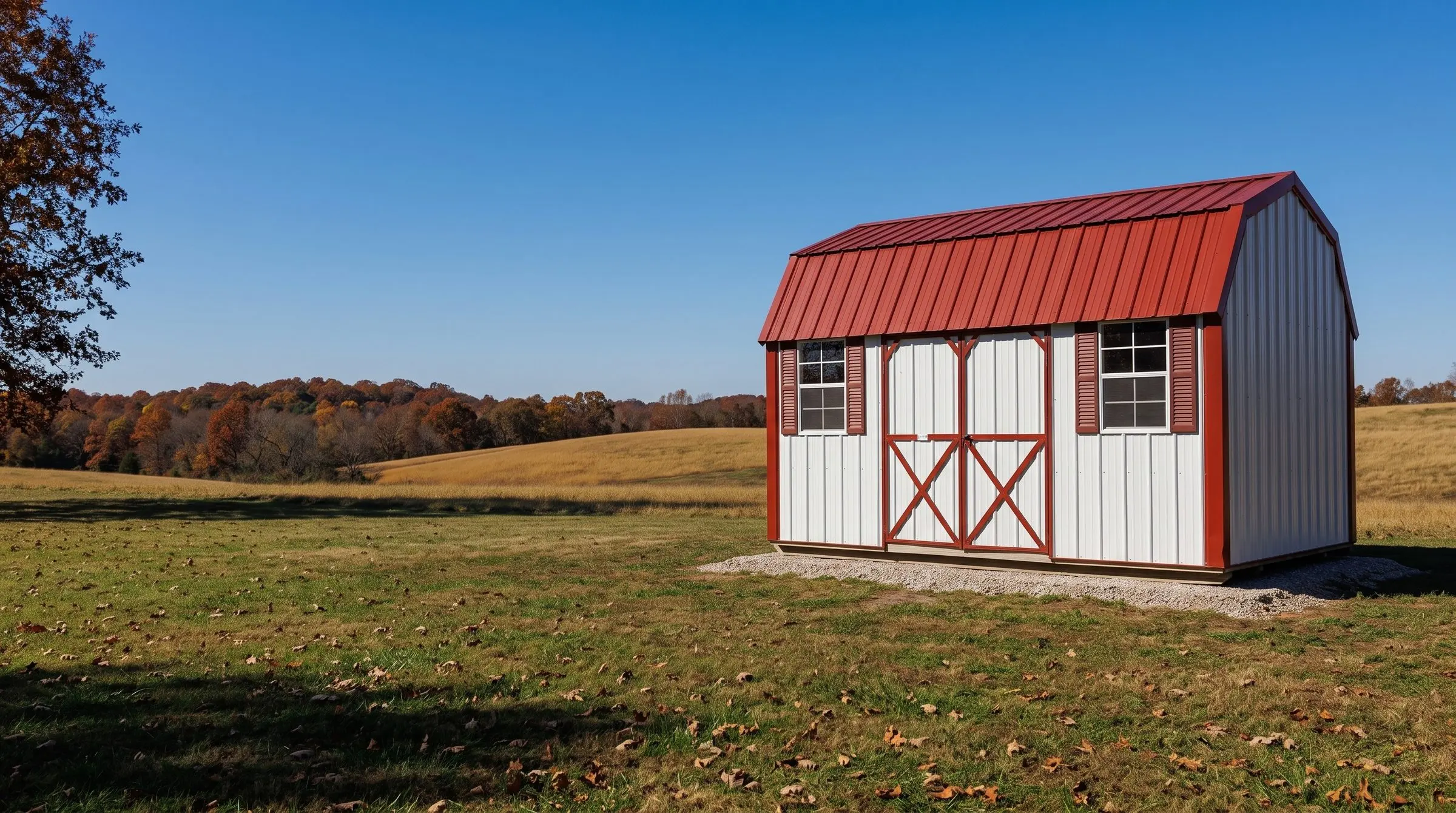 A white metal Hawthorn lofted garden barn with a red roof and red trim, set in a fall field in the Missouri Ozarks