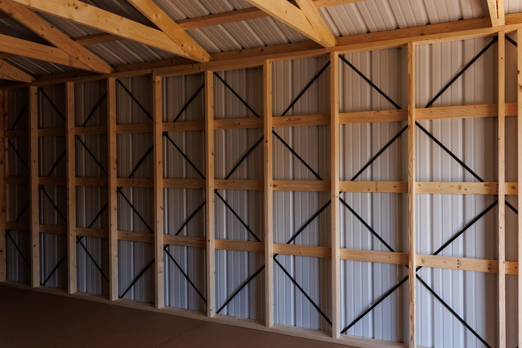 A long wall of studs, girts and black diagonal bracing inside a Hawthorn building